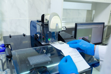 DNA laboratory. The expert puts the human DNA into the database using advanced laboratory technologies