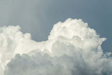 a huge cluster of fluffy cloudy under over cast sky after rain