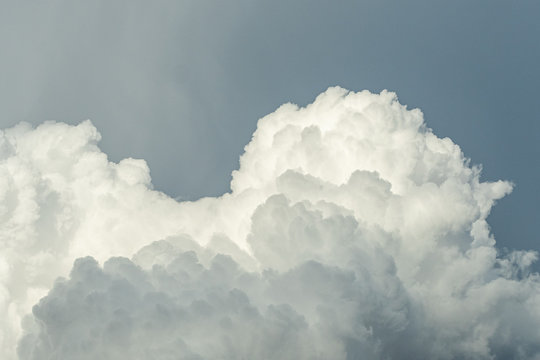a huge cluster of fluffy cloudy under over cast sky after rain
