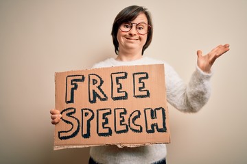 Young down syndrome woman holding protest banner of free speech for communication rights very happy...