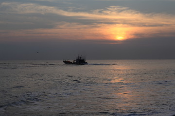 Long exposure sunrise seascape with Chinese fishing junks in the background