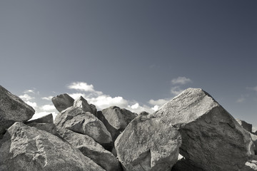 Pile of rocks against a blue sky.