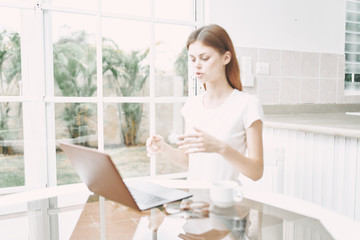 young businesswoman drinking coffee in office