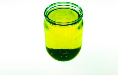 Colorful Kool-Aide in mason jars isolated against a white background