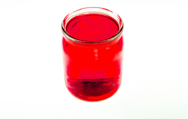 Colorful Kool-Aide in mason jars isolated against a white background