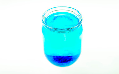 Colorful Kool-Aide in mason jars isolated against a white background