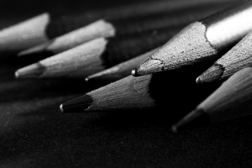 Wooden pencil on black background