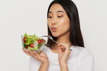 young woman eating salad