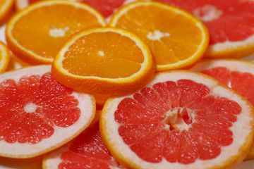 Fototapeta na wymiar Oranges and grapefruits, chopped
