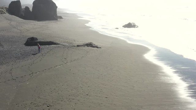 Woman Out Walking The Beach Looking For Treasures And Polished Rocks And The Ever Popular Agate In Gold Beach Oregon