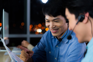Asian call center business people working late night shift for helping assistance customer...