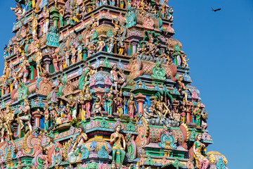 Hindu temple in Tamil Nadu, South India.  Sculptures on Hindu temple gopura (tower), sculpture of an Indian deity