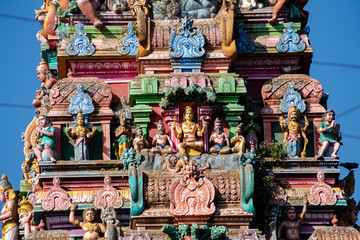 Naklejka premium Hindu temple in Tamil Nadu, South India. Sculptures on Hindu temple gopura (tower), sculpture of an Indian deity