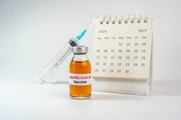SARS-Cov-2 vaccine, syringe injection and Calendar of April 2020