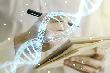 Creative concept with DNA symbol illustration and man hand writing in notebook on background....