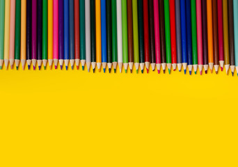 Overhead shot of pencils on paper. Frame of school supplies. Flatly
