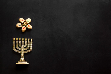 Menorah - traditional Jewish Candelabra - holiday Hanukkah concept on black background, top view, copy space