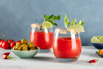 Bloody Mary cocktail with tomato juice, lime, and celery, with olives