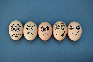 Funny eggs expressions concept with different emotions isolated on flat black background.