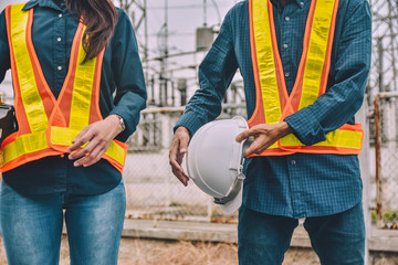 Engineer two people holding hard hat wear safety suit