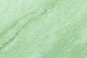 Texture of light green marble with olive lines of a pattern, macro background.