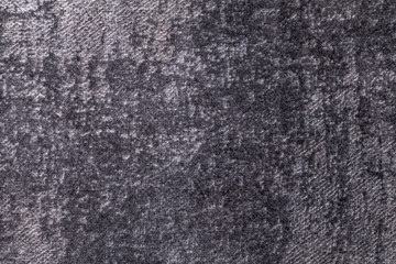 Dark gray and silver fluffy background of soft, fleecy cloth. Texture of black textile backdrop with shiny pattern.