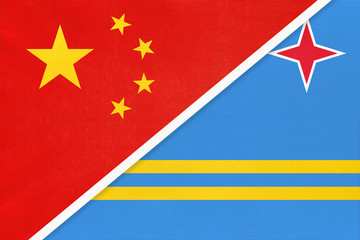 China or PRC vs Aruba national flag from textile. Relationship between asian and american countries.