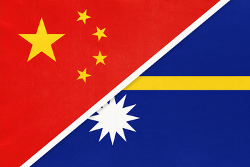 China or PRC vs Nauru national flag from textile. Relationship between Asian and Oceania countries.