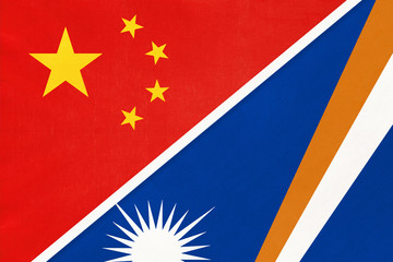 China or PRC vs Marshall Islands national flag from textile. Relationship between Asian and Oceania countries.