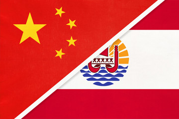 China or PRC vs French Polynesia national flag from textile. Relationship between Asian and Oceania countries.