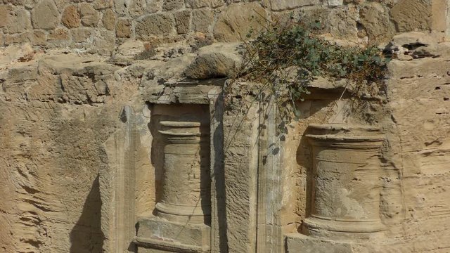 Fragment of the wall of the tomb. Filmed on the territory of the archaeological park Royal Tombs, near Paphos, Cyprus.