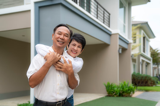 Portrait Of Mature Couple After Retirement Relaxing In New House