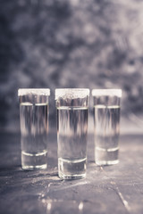 Tequila shots on the dark rustic background. Selective focus. Shallow depth of field.