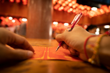 man writing on a card