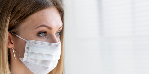 Nurse or doctor with face mask. Close up portrait of young caucasian woman model on white background