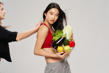young woman holding a bag full of groceries