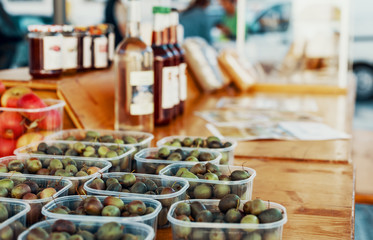 Organic olives on a wooden table at an authentic farmers market