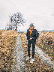 Adult woman jogging / exercising on a mountain road in nature.