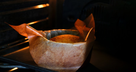 Baking a loaf of homemade bread from the oven in the kitchen
