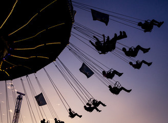 flying in the air on merry go round with purple sky in background