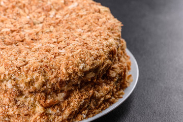 Fresh delicious cake napoleon with cream on a dark background