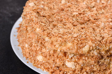 Fresh delicious cake napoleon with cream on a dark background