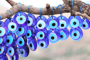 Evil eye charms hang from a tree in Cappadocia, Anatolia, Turkey