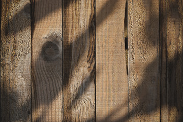 light and shadow on wood barn wall plank texture background, top view of old wooden table