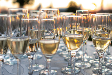 Many champagne glasses in sunset light