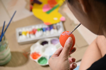 people painting easter egg custom pattern design with watercolor