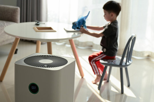 Air Purifier In Living Room With Kid Playing Inside Home