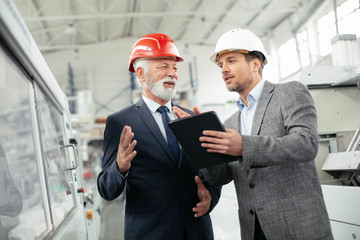 Colleagues working together. Workers in factory.	