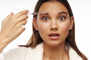 woman applying mascara