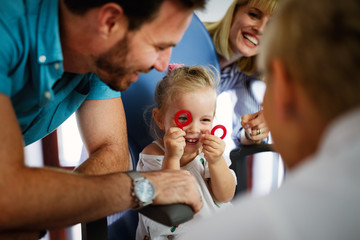 Ophthalmologist, optometrist checking child vision looking for problems and caring for eye